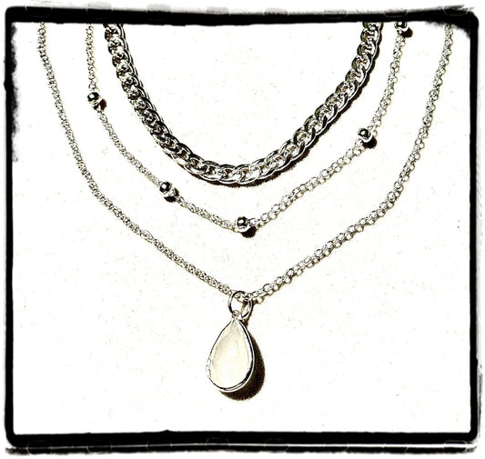 3 layer silver necklace with a white tear drop pendant